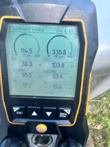 Digital HVAC gauge showing system pressure readings during an AC diagnostic in San Juan, Texas.