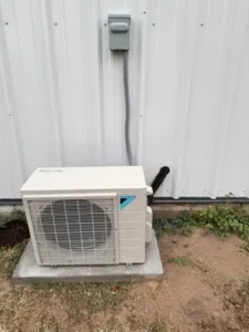 Daikin mini-split outdoor condenser mounted on wall brackets.