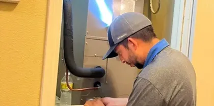 Technician installing an air conditioning unit
